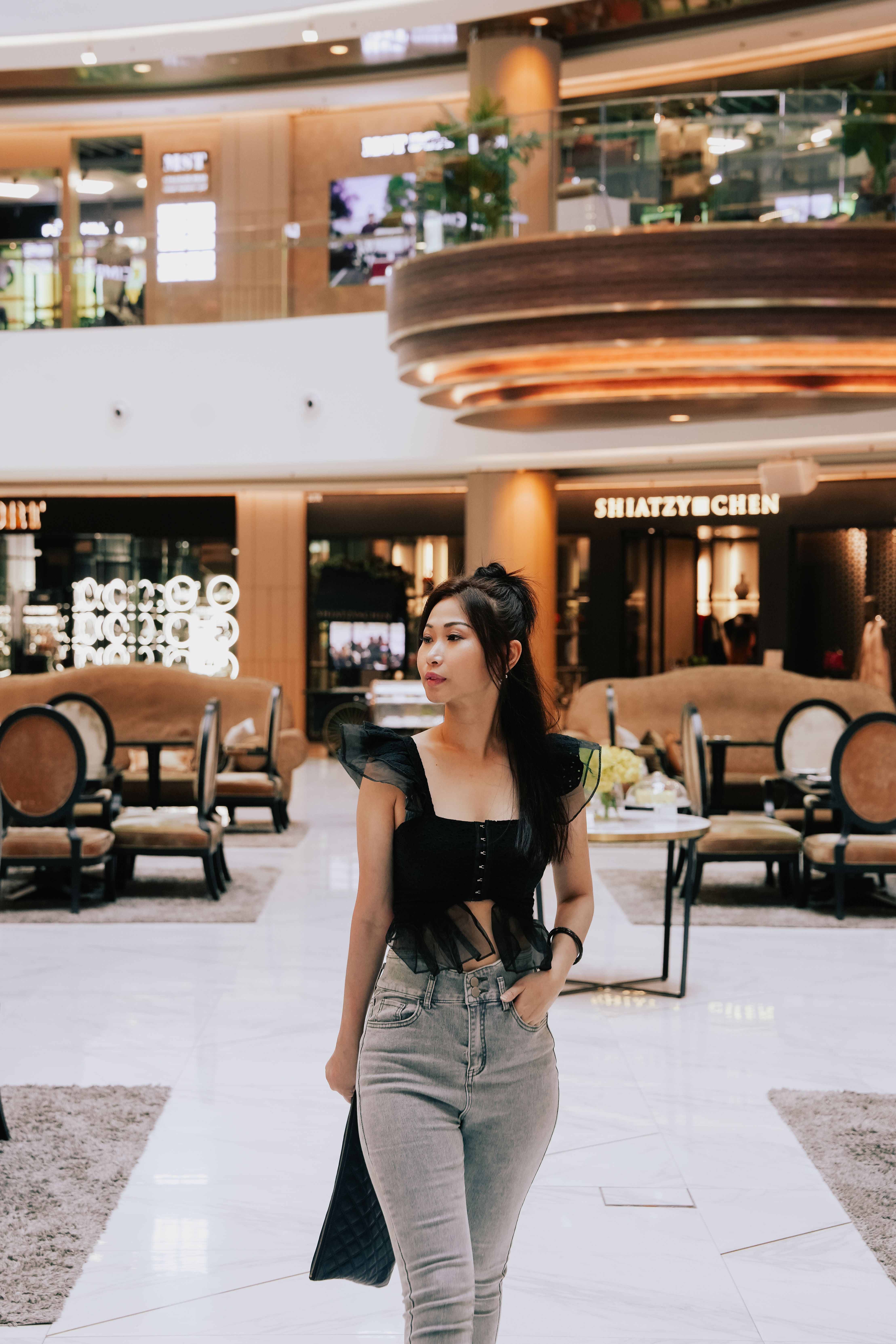 Fashionable Woman Strolling in Modern Mall