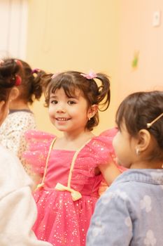 A group of joyful children playing indoors, highlighting cheerful interactions and vibrant atmosphere.