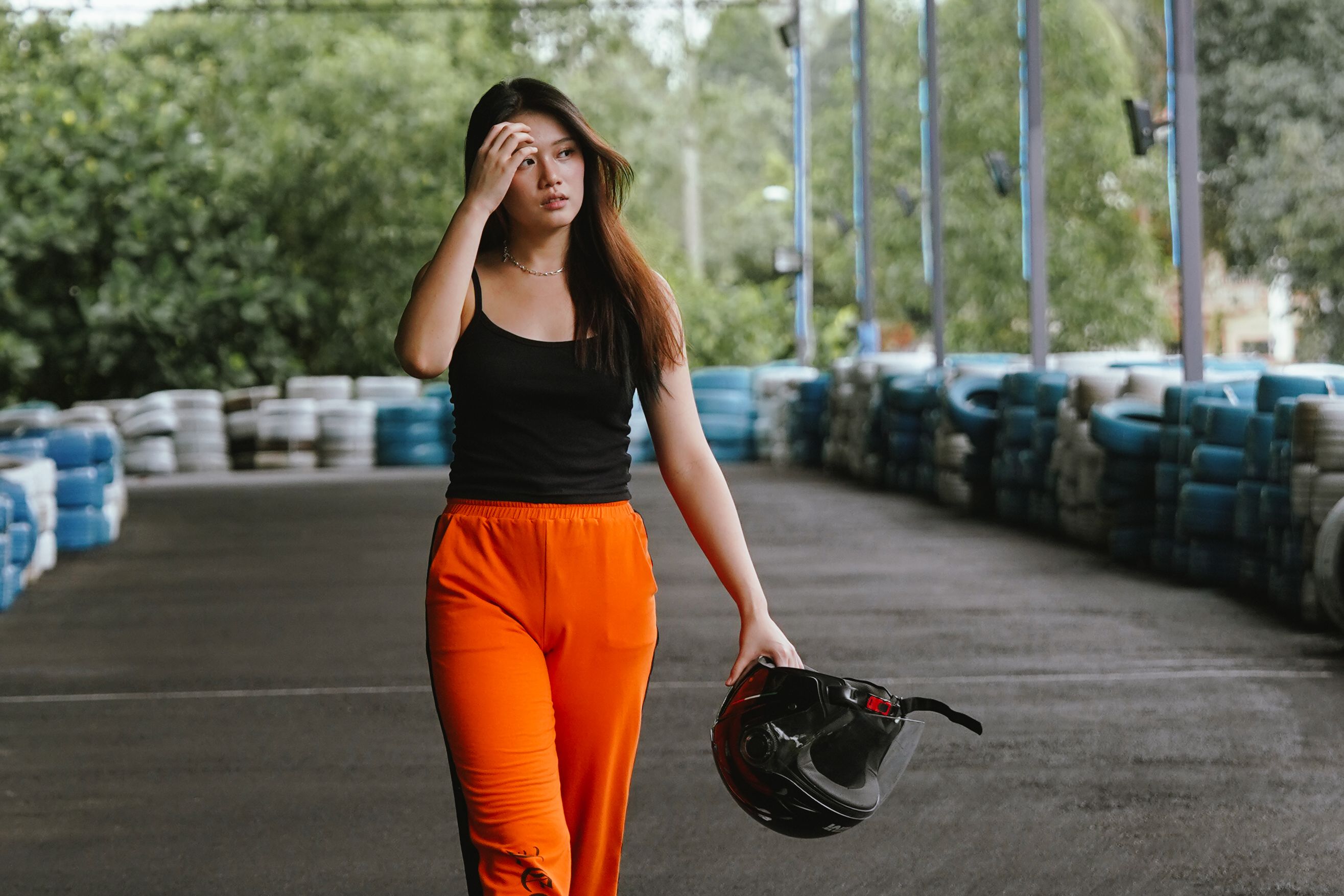 A person rubbing their temples in exhaustion while sitting in front of a laptop