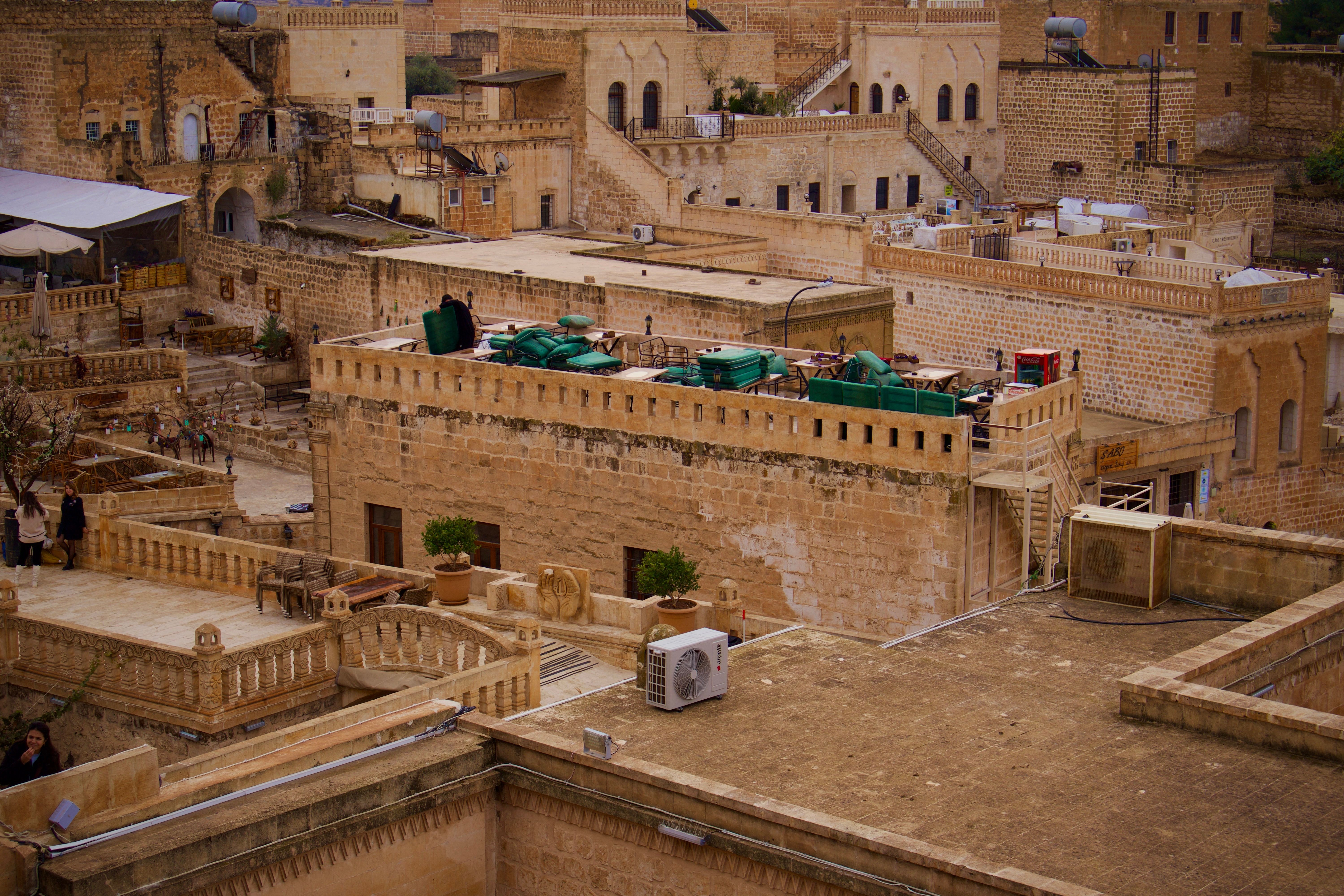 Rooftop terrace at a Jordanian hostel with students studying and sunset view