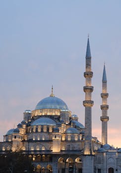 Stunning evening view of the Sultan Ahmed Mosque in Istanbul, showcasing its illuminated domes and minarets.