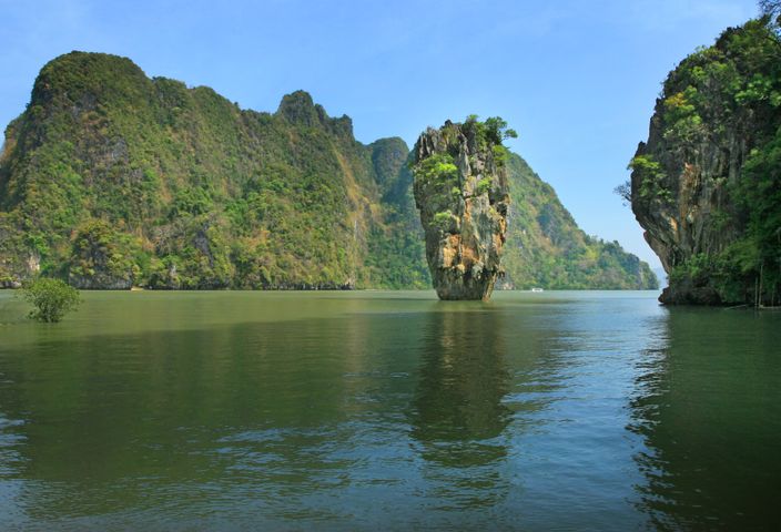 Tranquil view of James Bond Island in Thailand showcasing towering limestone cliffs and serene waters.