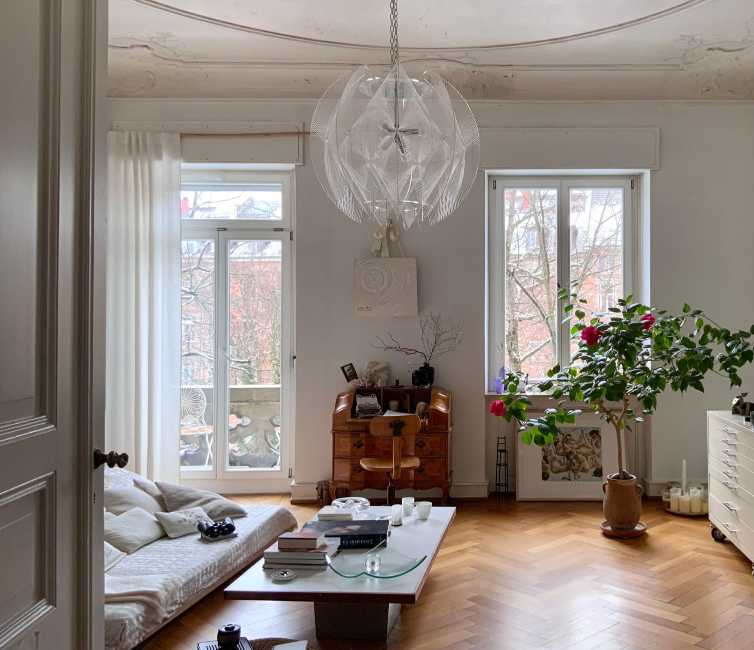 designer apartment transformation for cozy homes A stylish modern living room with large windows, minimalist decor, and natural light creating a cozy atmosphere.