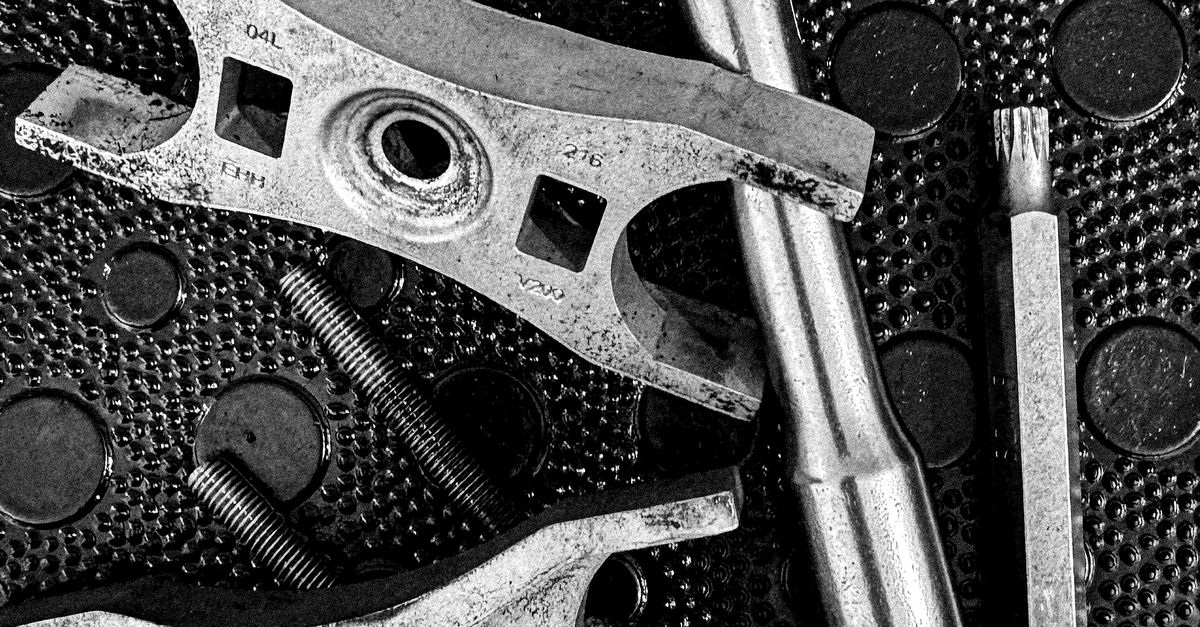 Extured Tools Industrial Tools on Textured Surface in Black and White · Free Stock Photo