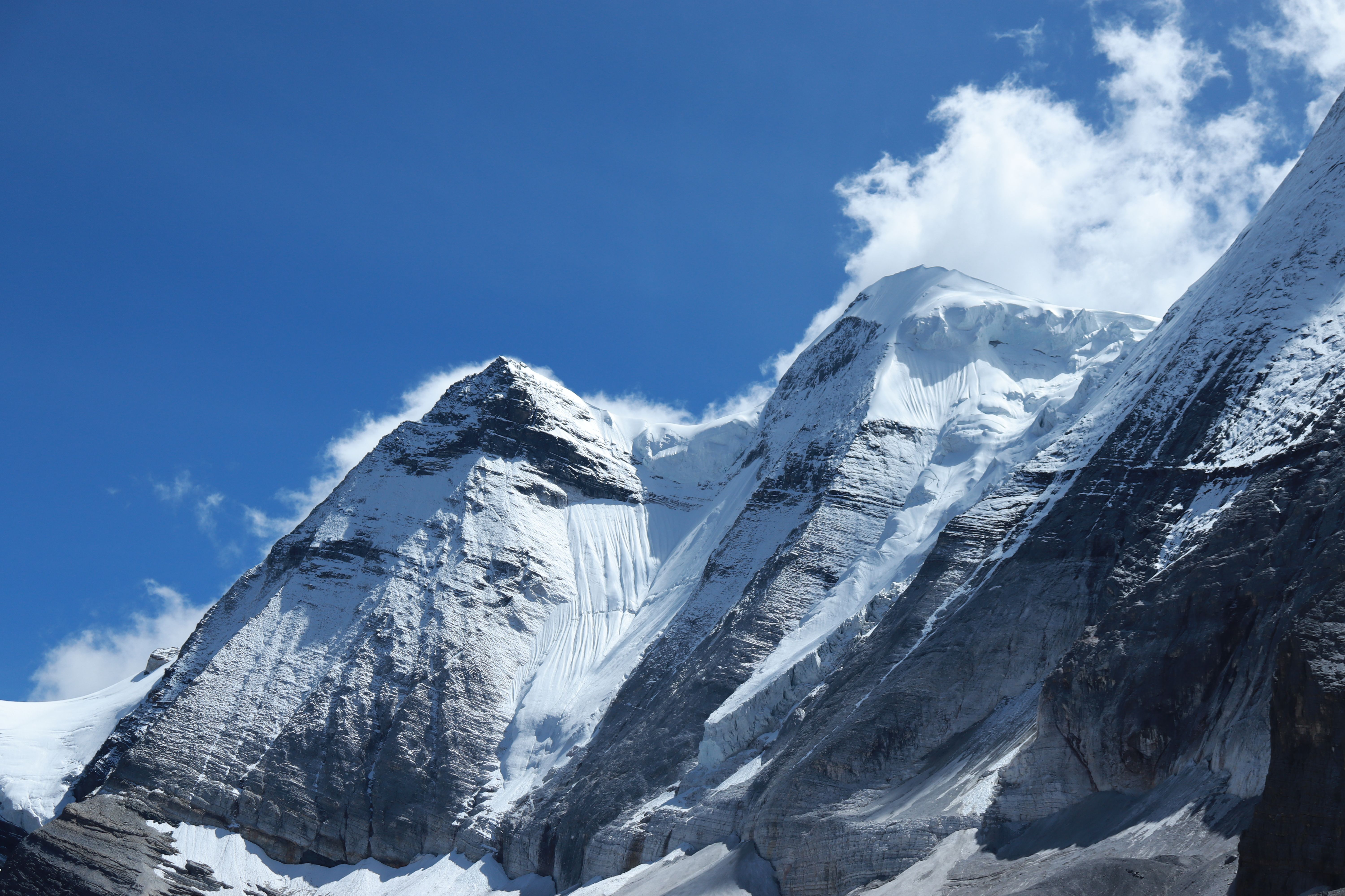 Stunning View Of Towering Snow-Covered Peaks Against A Bright Blue Sky, Showcasing The Beauty Of Nature.