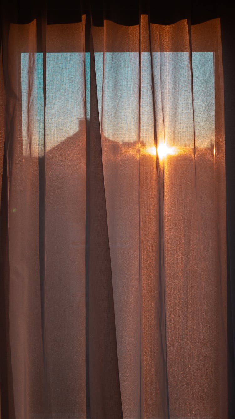 Window Curtain With Sunrise Beams