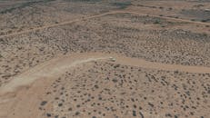 Aerial View of Off-Road Vehicle in Desert Landscape