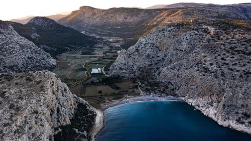 Free Stunning aerial view of a coastal mountain valley with sweeping landscapes and blue seas. Stock Photo