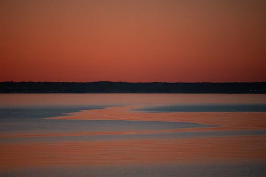 Beautiful sunrise over the calm waters of Stamford, Connecticut, capturing tranquil orange hues.