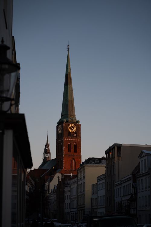 Free Gothic-style church tower silhouette in Lübeck city during twilight. Stock Photo