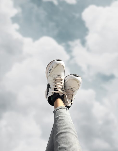 Person Wearing White Nike Running Shoes · Free Stock Photo