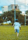Child Running on Grass in Vietnamese Park