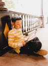 Young Boy Reading on Vietnamese Balcony