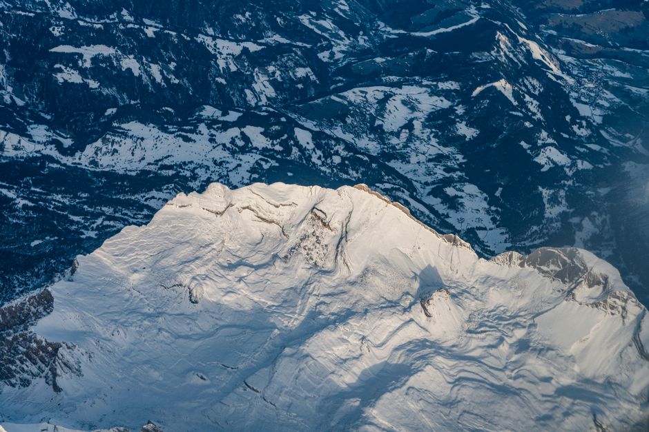 Stunning aerial shot of snow-covered peaks in the Italian Alps during winter.