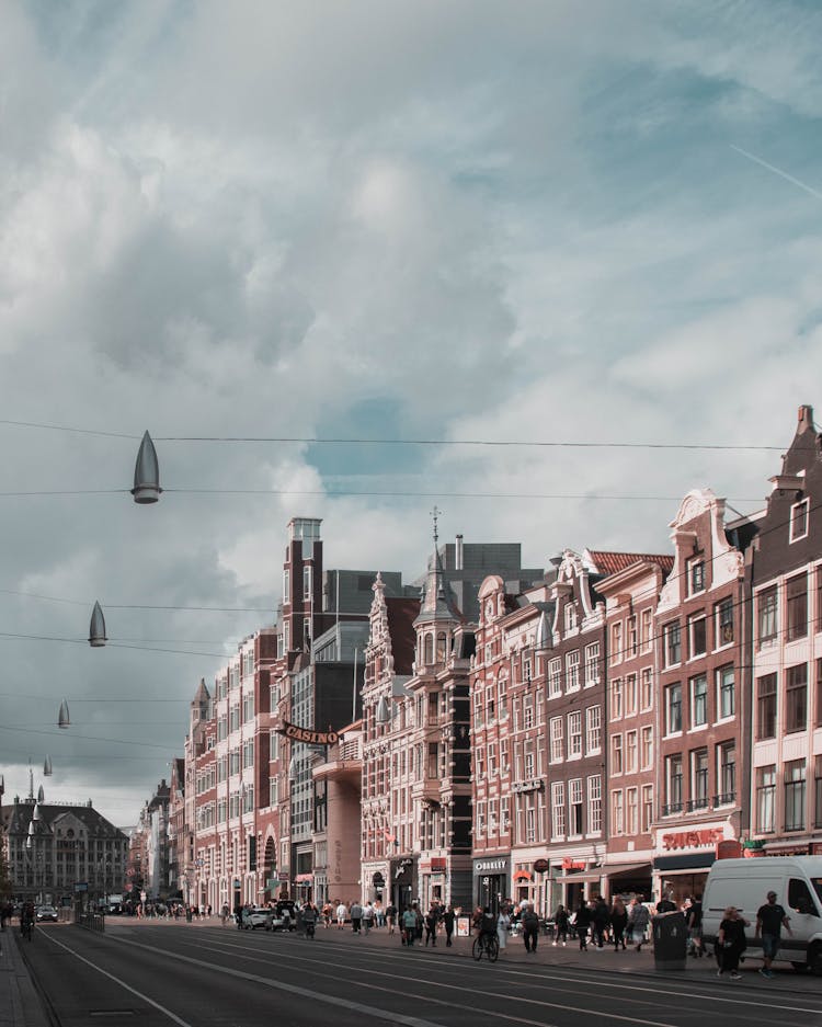 Photo Of People Walking On Sidewalk Near Buildings