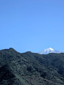 A stunning snow-capped mountain peak under a clear blue sky, showcasing natural beauty.