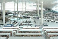 A spacious, modern library with rows of bookshelves and seating areas for study.