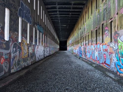 Free Colorful graffiti art decorates a long tunnel in Truckee, showcasing vibrant urban creativity. Stock Photo