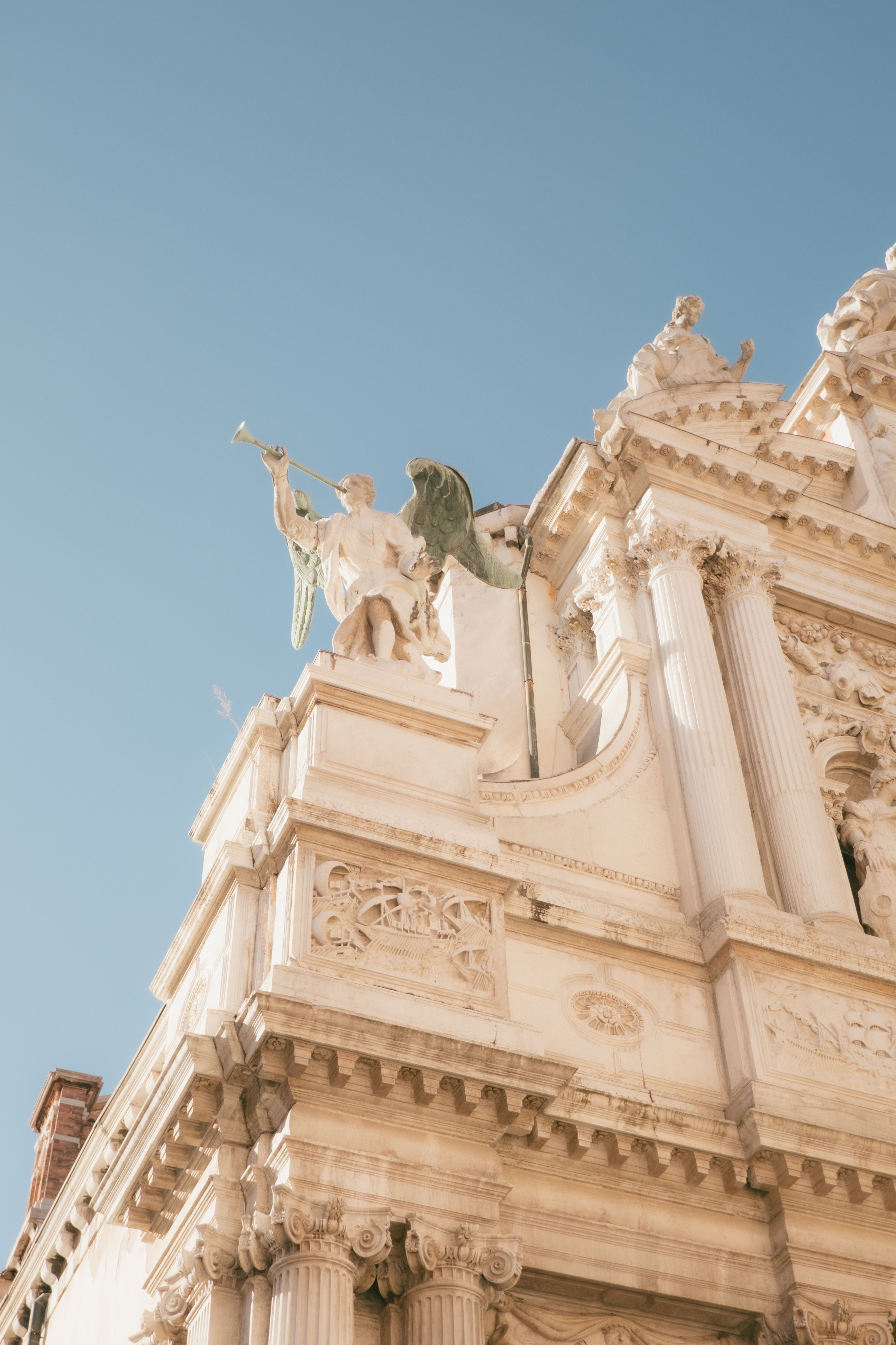 Ornate Angel Statue on Historical Building · Free Stock Photo