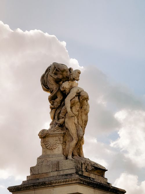 Free Detailed marble sculpture in Rome captured against a serene cloudy sky, showcasing intricate artistry. Stock Photo