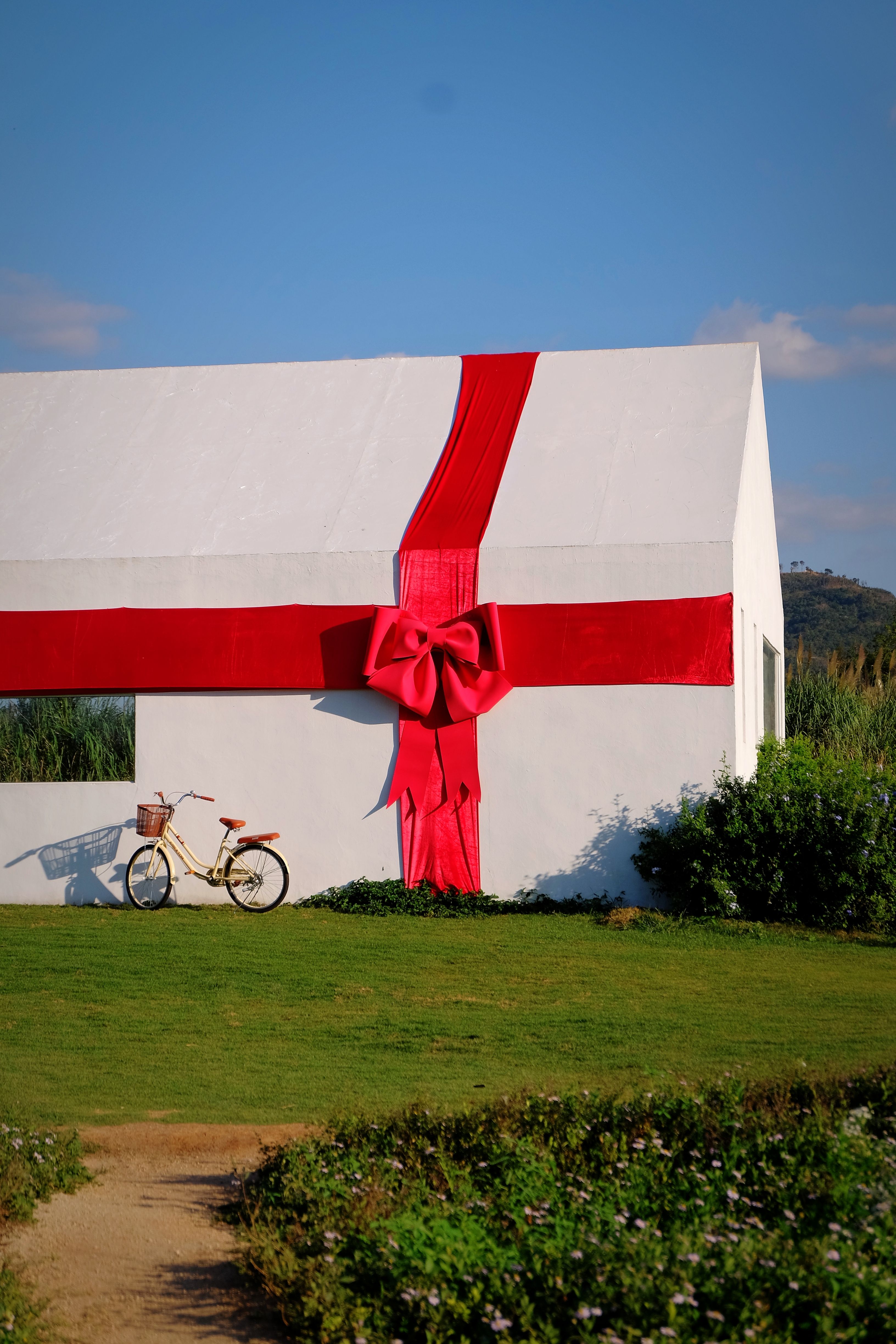 House Wrapped with Red Ribbon Outdoors · Free Stock Photo