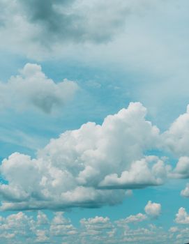 Tranquil image of white clouds against a bright blue sky, perfect for relaxation themes.