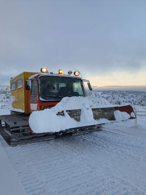 Free A snowplow clearing snow on a winter day in Karpacz, Poland, with scenic snowy landscape. Stock Photo