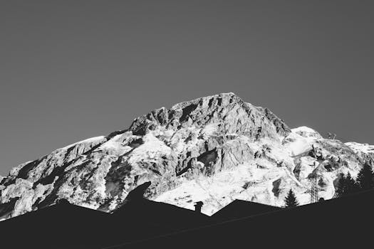 Black and white panorama of snow-covered Alpine peaks in Austria, captured in winter.