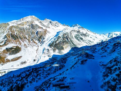 Free A breathtaking aerial view of the Austrian Alps covered in snow, showcasing a winter wonderland. Stock Photo