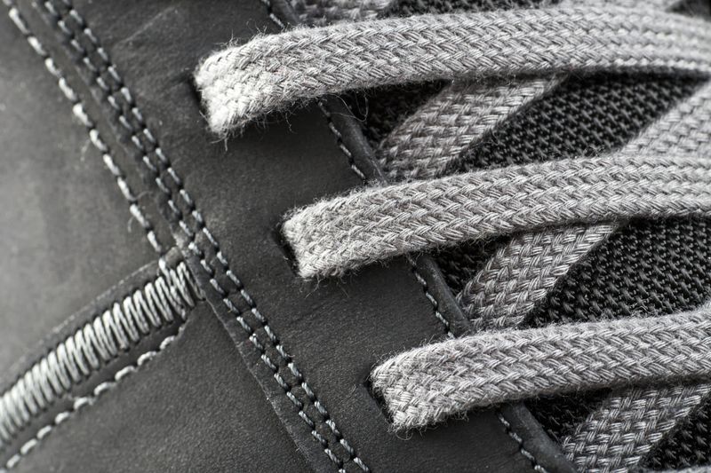 Macro detail of flat laces threaded through a running shoe upper — photo by Valentin Ivantsov on Pexels