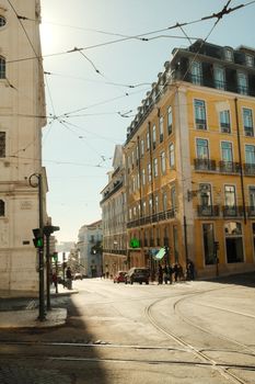 Charming street scene in Lisbon with classic architecture and sunlight.