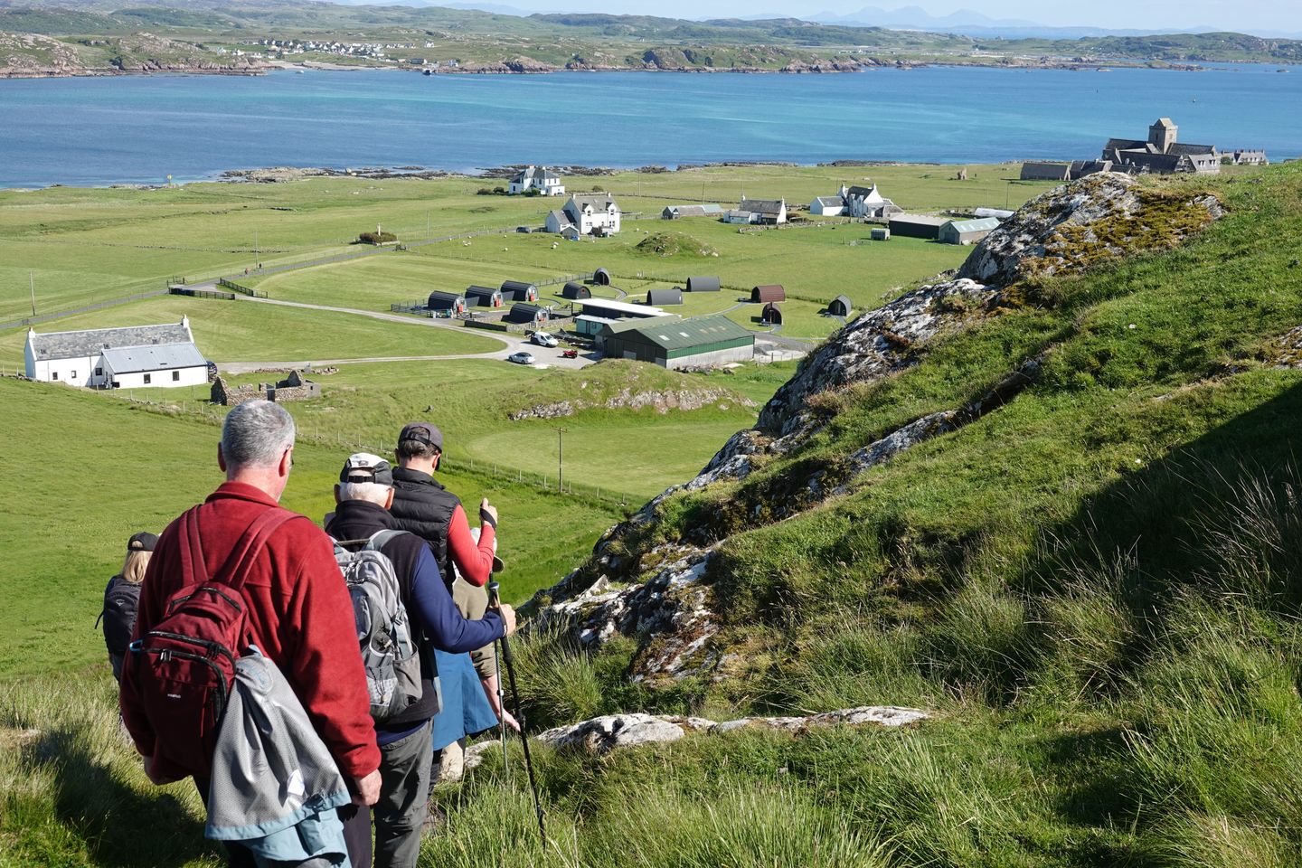 A walking group following a coast path above a crofting village — photo by John Bailer on Pexels
