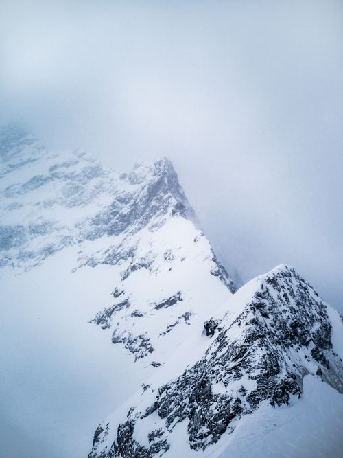 Free Breathtaking aerial view of snow-covered peaks in Lauterbrunnen, Switzerland during winter. Stock Photo