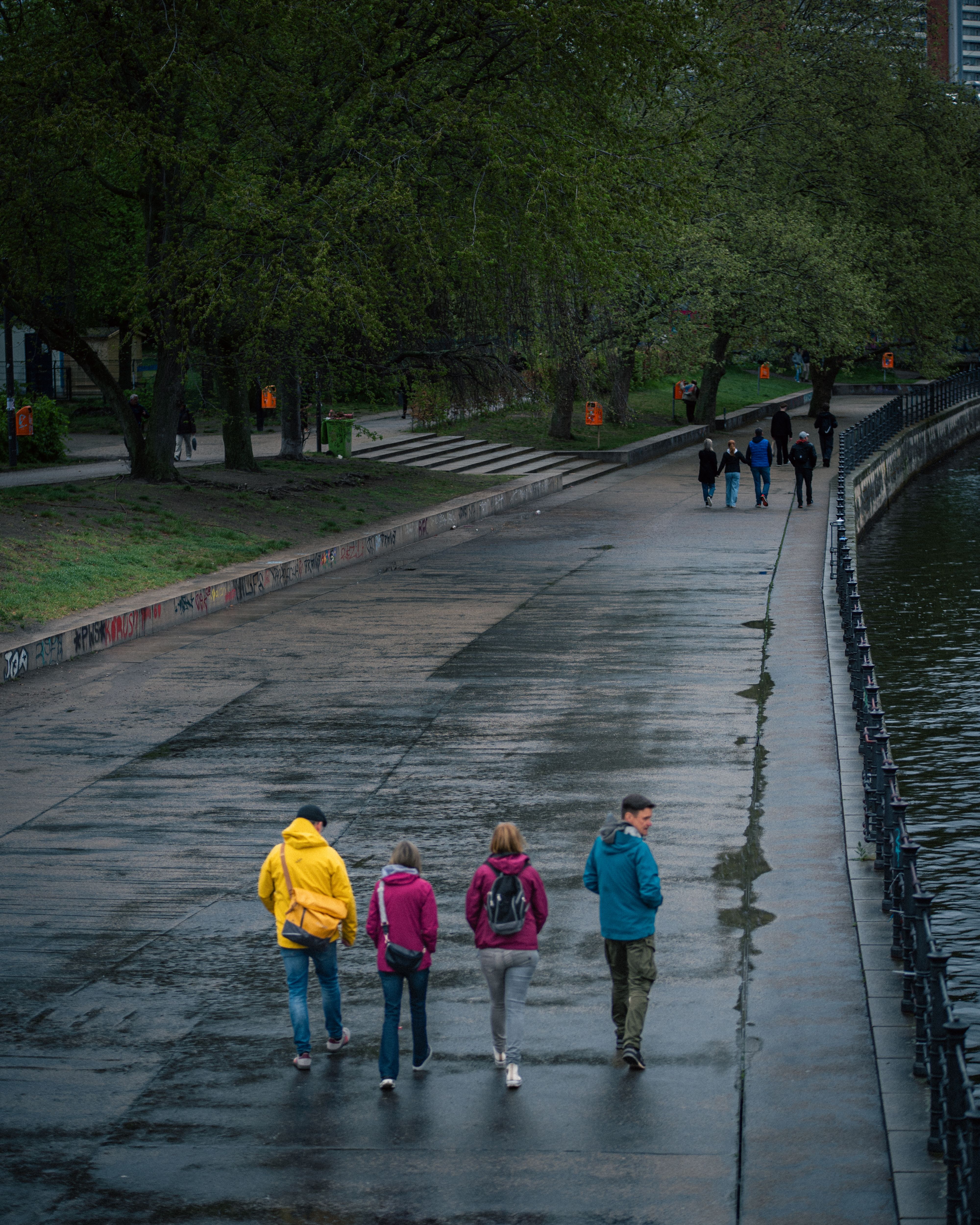Casual Walk Along Urban Riverside Pathway · Free Stock Photo