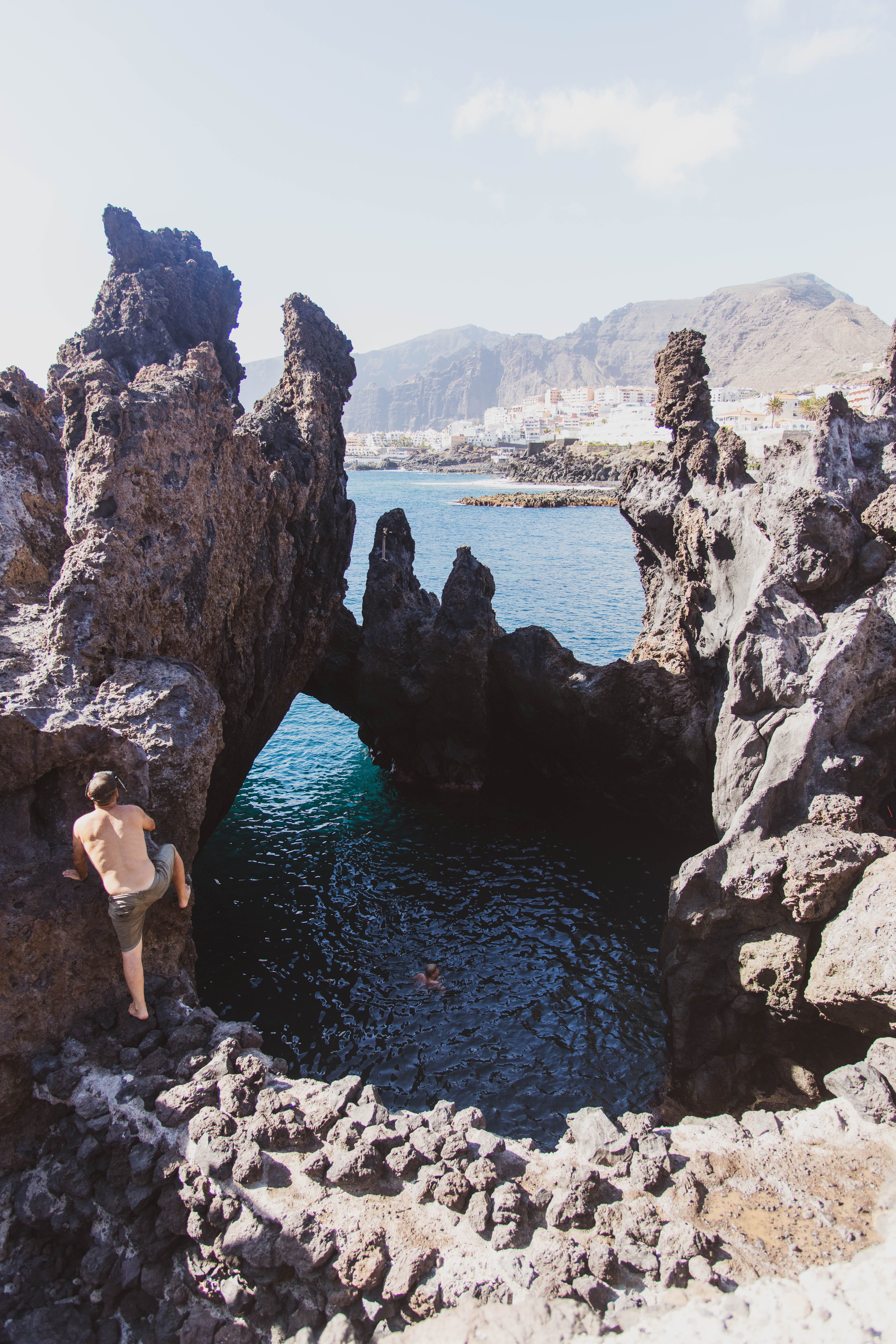 Man Cliff Diving into Natural Rock Pool · Free Stock Photo