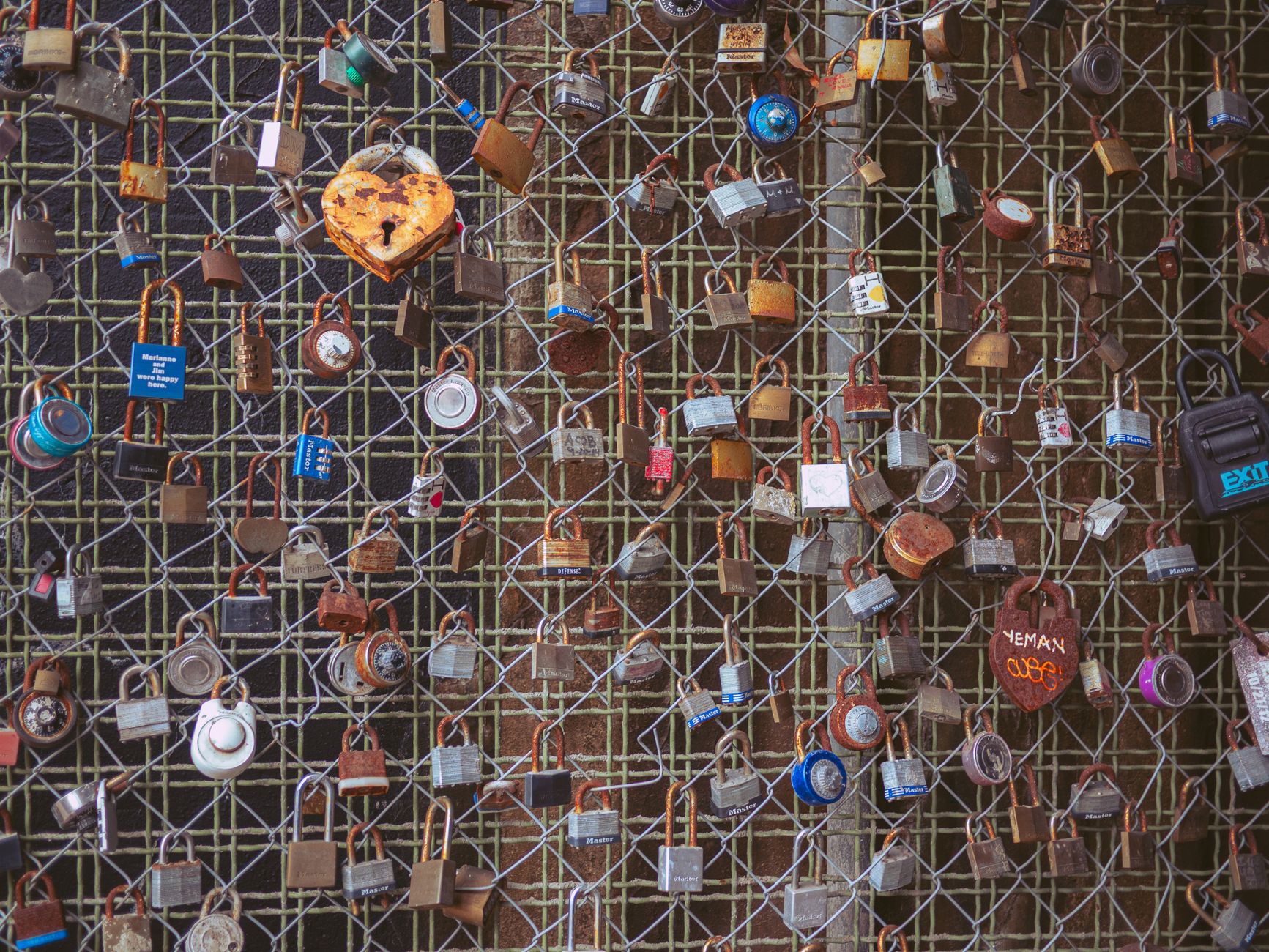 A collection of love locks on a fence, symbolizing everlasting bond and romance.