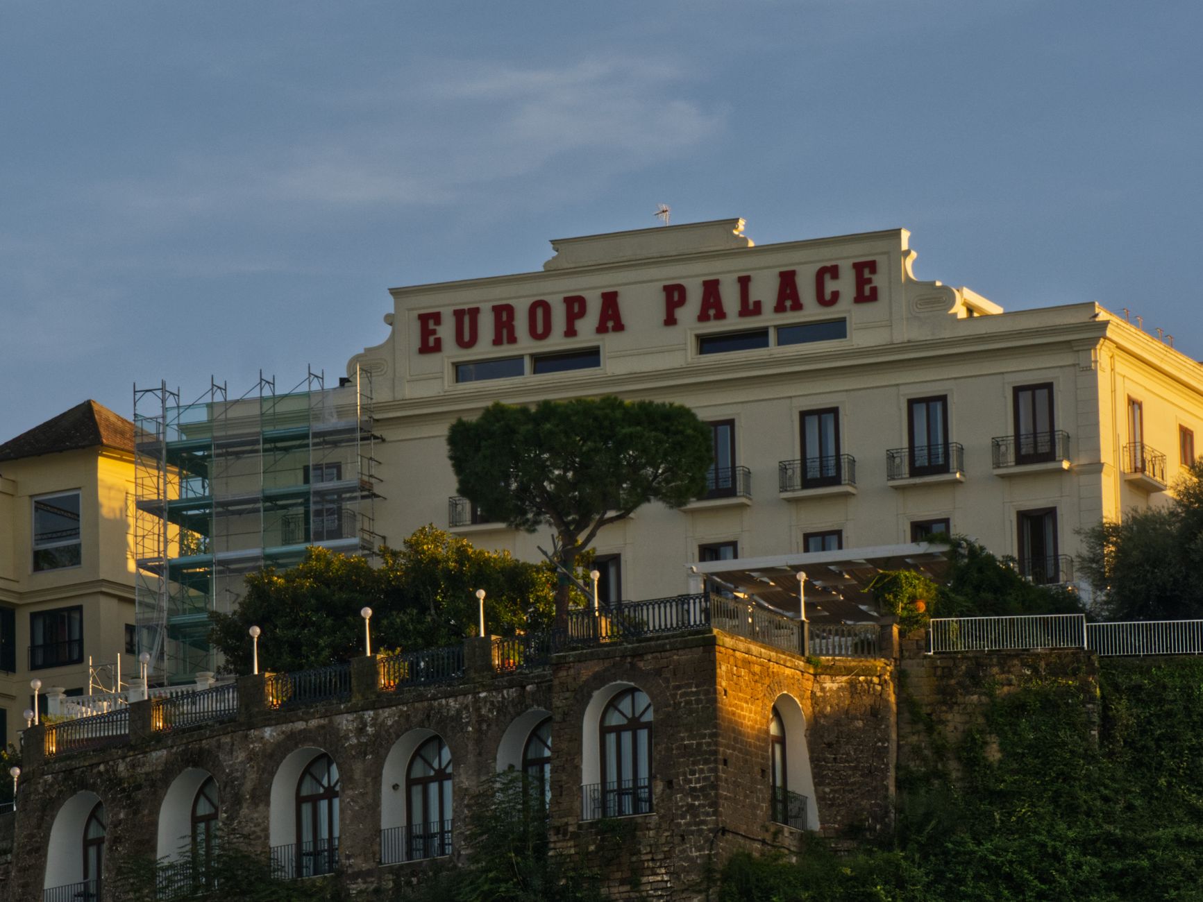 Europa Palace Hotel facade illuminated by warm sunset light capture. Related image for Hospitality in Europe: How Brands Can Improve Performance.