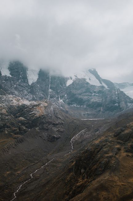 Dramatic Andean landscape with mist and rugged mountain peaks near Cuzco, Peru.