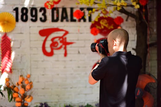 A person photographs colorful Tet festival decorations in Dalat.