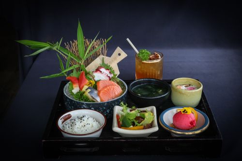 Free Vibrant Japanese bento box featuring fresh sashimi and traditional side dishes, beautifully presented. Stock Photo