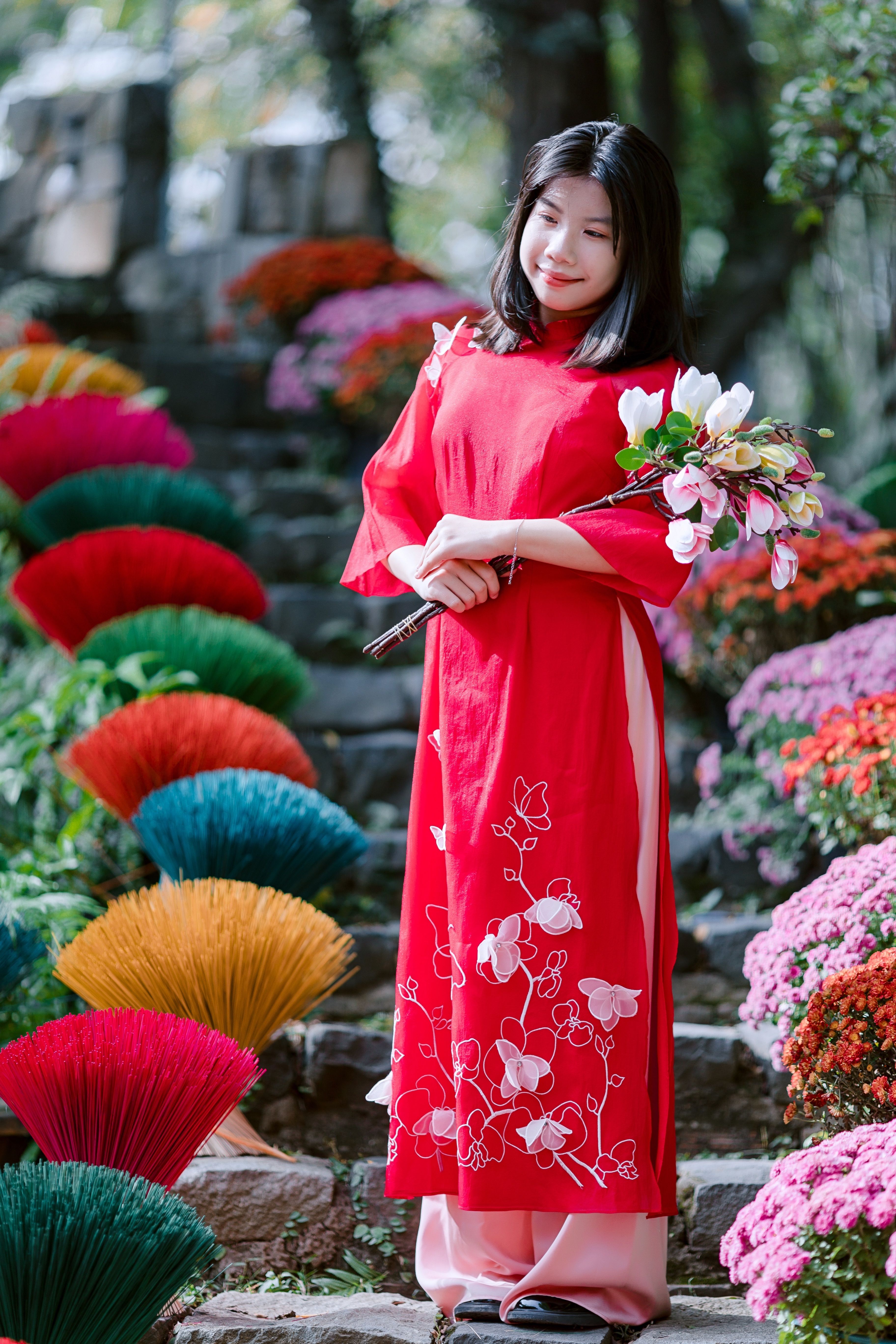 Asian Woman in Red Dress Holding Flowers Outdoors · Free Stock Photo