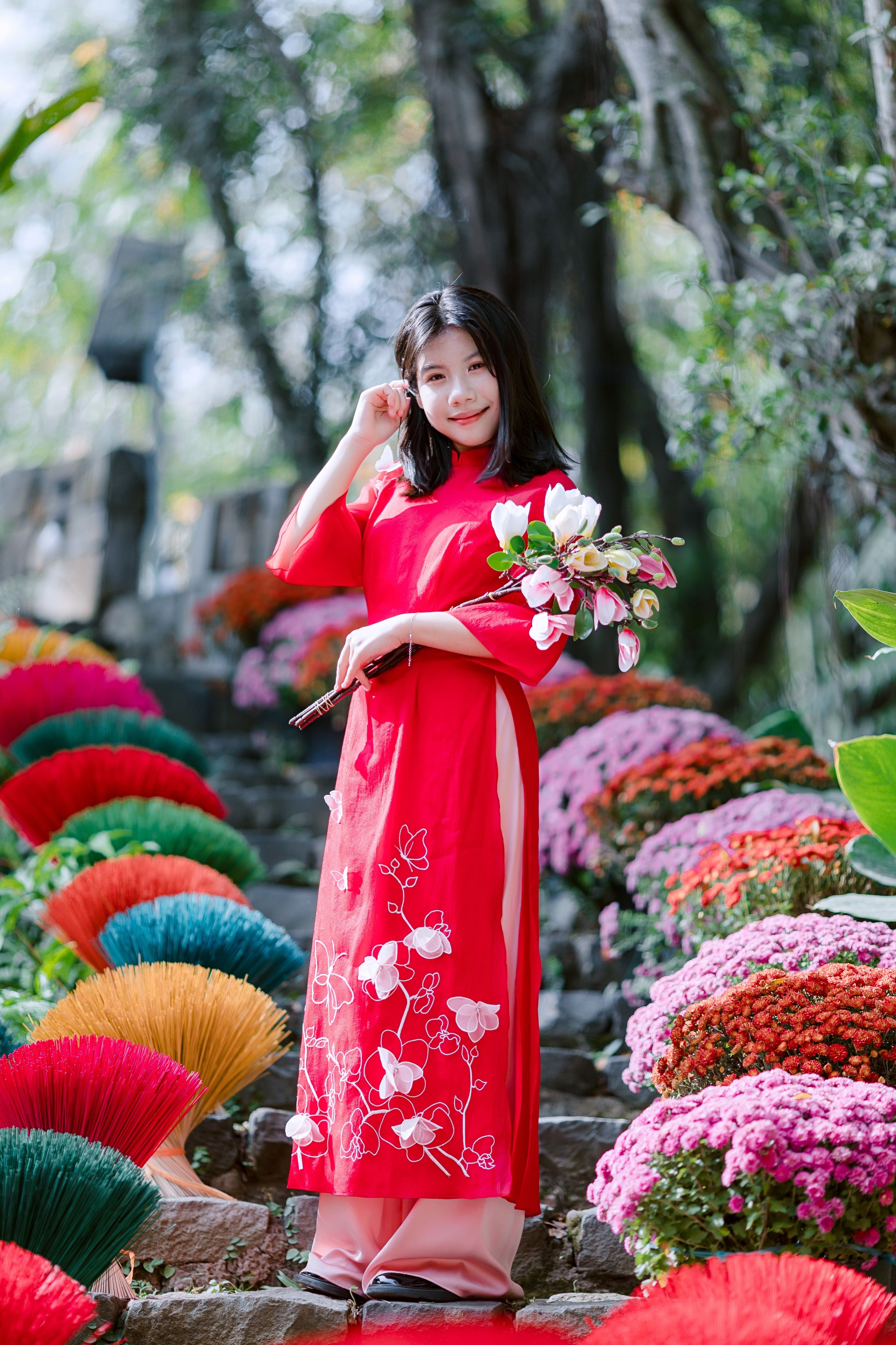Woman in Traditional Red Dress with Bouquet Outdoors · Free Stock Photo