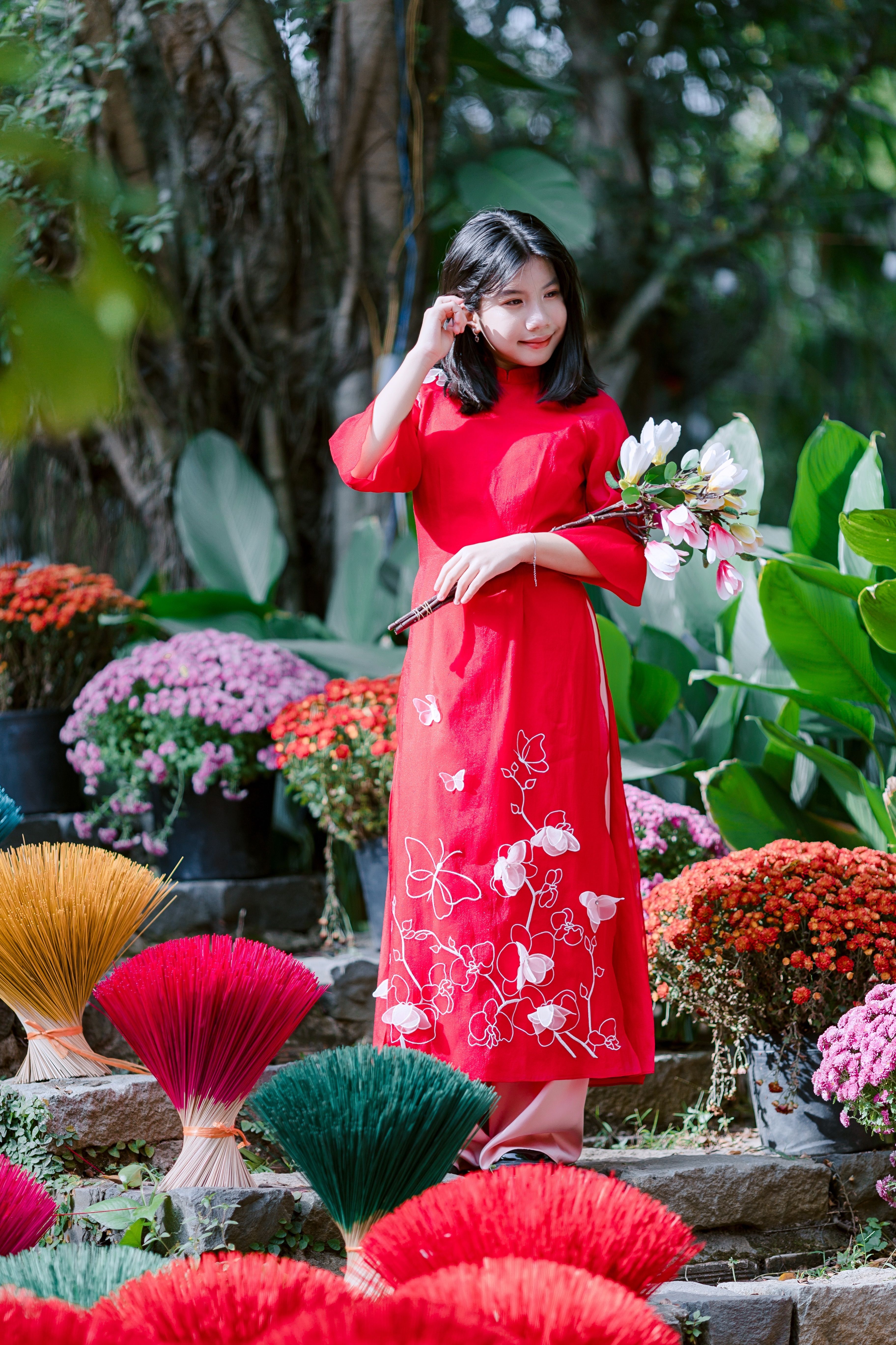 Young Woman in Red Dress Amidst Colorful Flowers · Free Stock Photo