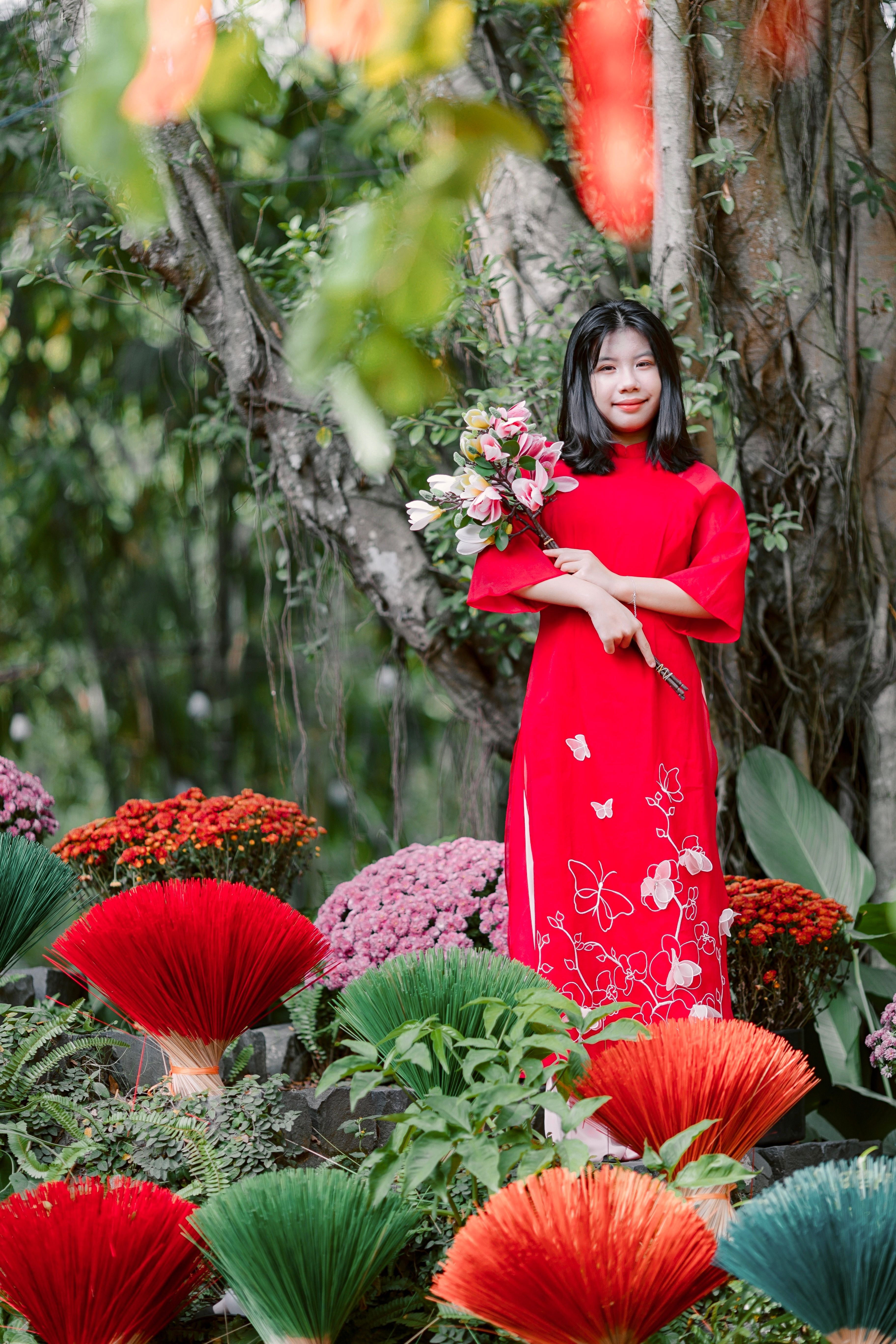 Woman in Red Traditional Dress with Floral Bouquet · Free Stock Photo
