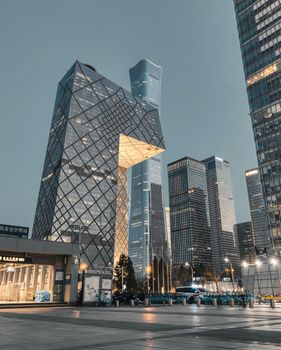 A dramatic view of Beijing's iconic CCTV Headquarters at dusk, showcasing modern architecture.