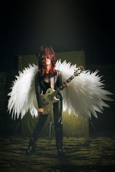 Dynamic image of a guitarist with angel wings in Tlaxcala, Mexico.