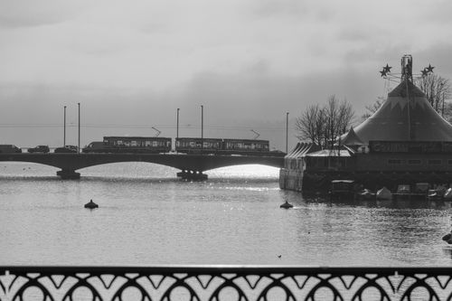 Free A scenic winter view of a bridge and festive tent in Zurich, Switzerland. Stock Photo