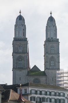 Capture the iconic twin towers of Grossmünster in Zurich on a clear day, reflecting historical architecture.
