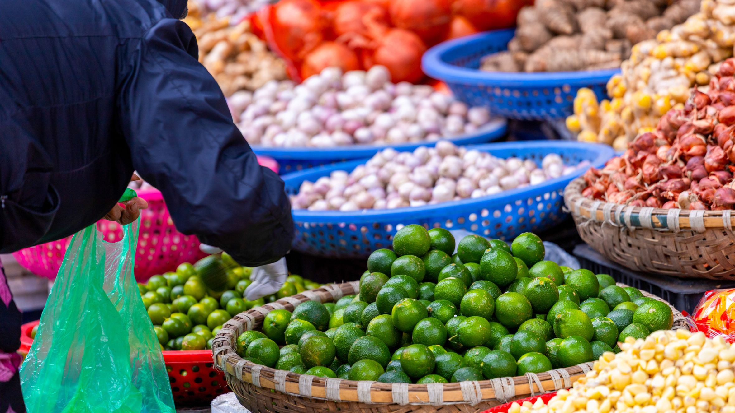 Bright and colorful display of fresh produce at a bustling Hanoi street market.
