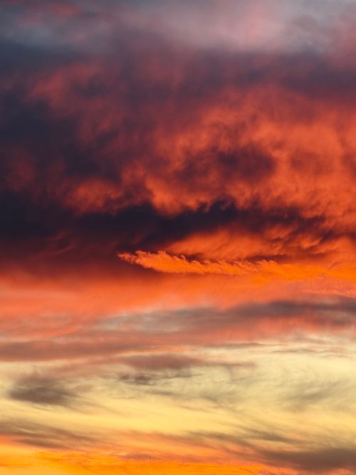 Free Vivid sunset sky with fiery orange and deep purple hues creating a dramatic scene. Stock Photo